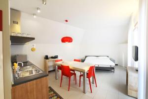 a kitchen with a table and chairs and a bed at Lago & Monte Varese Apartments near Hospital and University in Varese