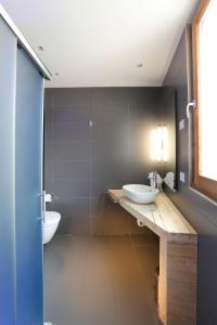 a bathroom with two sinks and two toilets at Lago & Monte Varese Apartments near Hospital and University in Varese +13 photos