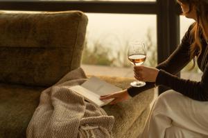 two women sitting on a couch with a glass of wine at MarinaPark Beach Resort Soal | Beachfront villas in Workum