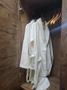 a row of white towels hanging in a closet at Desitas home in Plovdiv +20 photos