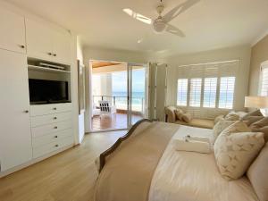 a bedroom with a large bed with a view of the ocean at Pebble Beach Seafront Condo in Swakopmund