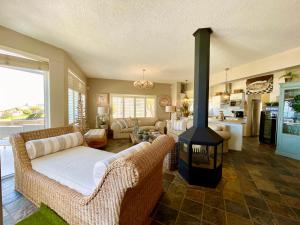 a living room with a fireplace and a couch and a stove at Pebble Beach Seafront Condo in Swakopmund