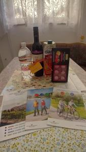 a table with books and a bottle of wine and a bunch thereof at Apartments Heidi in Portorož