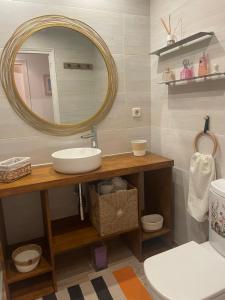 a bathroom with a sink and a mirror and a toilet at Pals apartament centric in Pals +18 photos