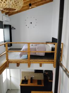 a room with two bunk beds and a clock on the wall at Apartamento Catalina in Algodonales