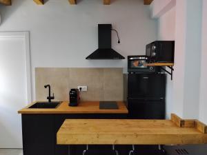 a kitchen with a sink and a black refrigerator at Apartamento Catalina in Algodonales +15 photos
