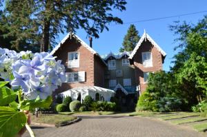 a house with flowers in front of it at La vanguardia by Don Ramon Hotel Boutique & Spa in Canela