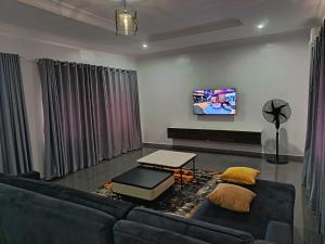 a living room with a couch and a table at Kbazz apartments in Ibadan