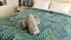 a rolled up towel on top of a bed at Entire villa with private pool and seaview Albion Mauritius in Albion +55 photos
