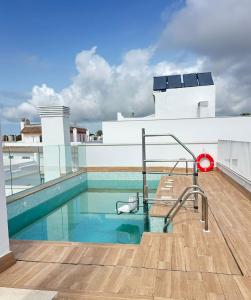 a swimming pool on the roof of a building at ABA Malaguita in Conil de la Frontera