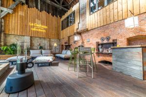 a large living room with a fireplace and a brick wall at LOFT d'exception Hypercentre avec Piscine in Brive-la-Gaillarde