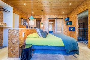 a bedroom with a bed in a stone wall at LOFT d'exception Hypercentre avec Piscine in Brive-la-Gaillarde +50 photos