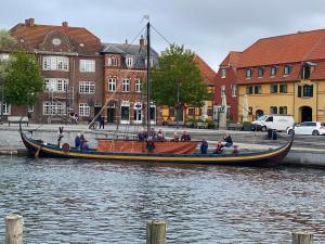 a group of people on a boat in the water at City gæstehus kerteminde in Kerteminde