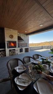 a dining table with chairs and a fireplace on a patio at Shamuk Homes in Chimgan
