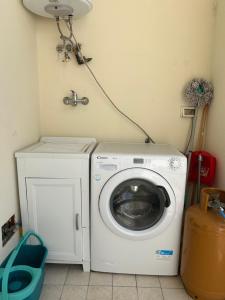a washer and dryer in a corner of a room at Santu Marcu apartment in Decimomannu