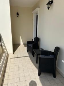 a waiting room with chairs and a table at Santu Marcu apartment in Decimomannu