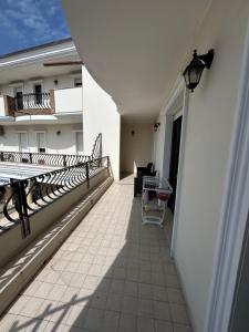 a balcony with a table and chairs on a building at Santu Marcu apartment in Decimomannu +33 photos