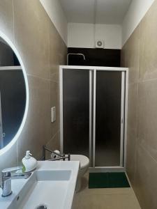 a bathroom with a shower with a sink and a toilet at CORFÙ 19 Bed & Breakfast in Schiavonea