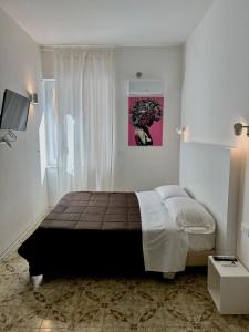 a bedroom with a large bed in a room at CORFÙ 19 Bed & Breakfast in Schiavonea