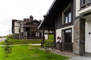 two people standing in the doorway of a house at Greitser Elit Chalet in Bukovel