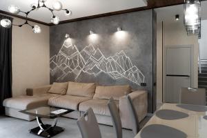 a living room with a couch and two tables at Greitser Elit Chalet in Bukovel +19 photos