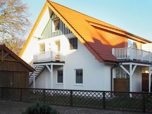 a large white house with an orange roof at Stems-W4 in Prerow