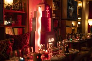 a restaurant with a bar sign in a room at Hôtel Grand Amour in Paris