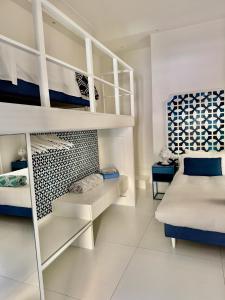 a white room with a bed and a bunk bed at MARILISE - La maison blue private garden & terrace in Meta