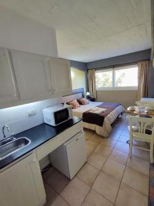 a kitchen with a bed and a sink in a room at Plaza Milenium in San Rafael