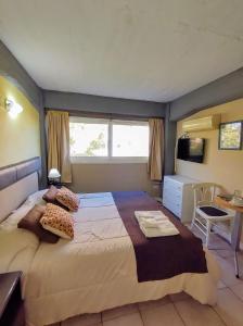 a bedroom with a large bed and a television at Plaza Milenium in San Rafael +54 photos
