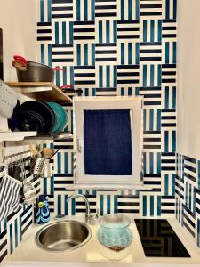 a kitchen with a sink and a blue and white wallpaper at MARILISE - La maison blue private garden & terrace in Meta +32 photos