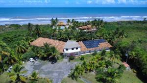 an aerial view of a house with solar panels on it at Costamar Pousada e Restaurante in Una +27 photos