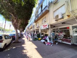 a group of people standing in front of a store at R suite delux in Netanya