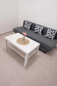 a living room with a couch and a white coffee table at R suite delux in Netanya +1 photo