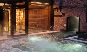 a hot tub in a room with a brick wall at Hope Street Hotel in Liverpool