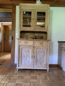 a wooden cabinet in a room with a wooden floor at Ferienhaus im Bergidyll in Sankt Jakob in Defereggen