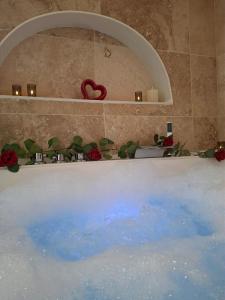 a bath tub with a red heart on top of it at La Suite Balinaise in Quimper