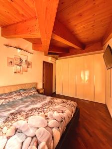 a large bed in a room with a wooden ceiling at Raggio di Sole in Montesilvano
