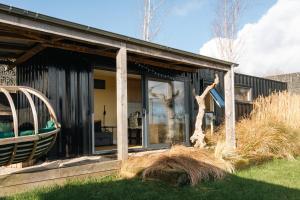 a house with a window and a chair in the yard at Square 32 Luxury Shipping container in Knockcloghrim