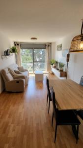a living room with a table and a couch at Apartamento VALLFOGONA Relax in Santa Bárbara
