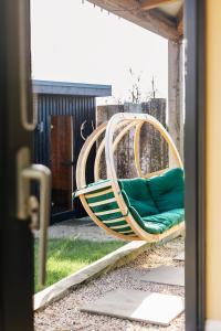 a wooden chair sitting on a patio at Square 32 Luxury Shipping container in Knockcloghrim