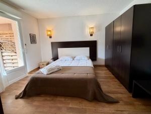 a bedroom with a large bed and a window at SAINT-FLORENT Studio PISCINE FLO300-146 in Saint-Florent