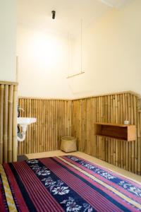 a bedroom with a bed with a rug on the floor at Kokomo Yogyakarta in Yogyakarta