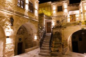a staircase in a building with lights on it at Göreme Cave Suites in Göreme