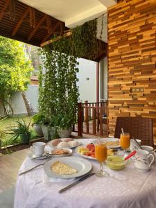 a table with breakfast food and orange juice on it at Sithuka Villa Bentota in Bentota +95 photos