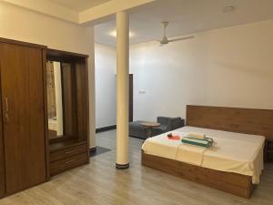 a bedroom with a bed and a pole at Lanka Villa Beruwala in Beruwala