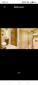 a picture of a bathroom with a toilet and a sink at HotAlnovaiN in Agra