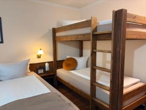 a bedroom with two bunk beds and a ladder at Hotel Rebstock in Rust