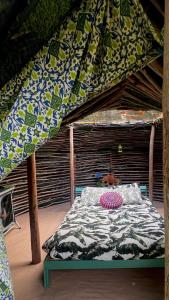 a bed under a canopy in a room at Selfmade Yurt - NaturViana in Viana do Castelo
