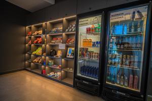 a refrigerator filled with lots of bottles of drinks at Hotel Opuka in Sorriso